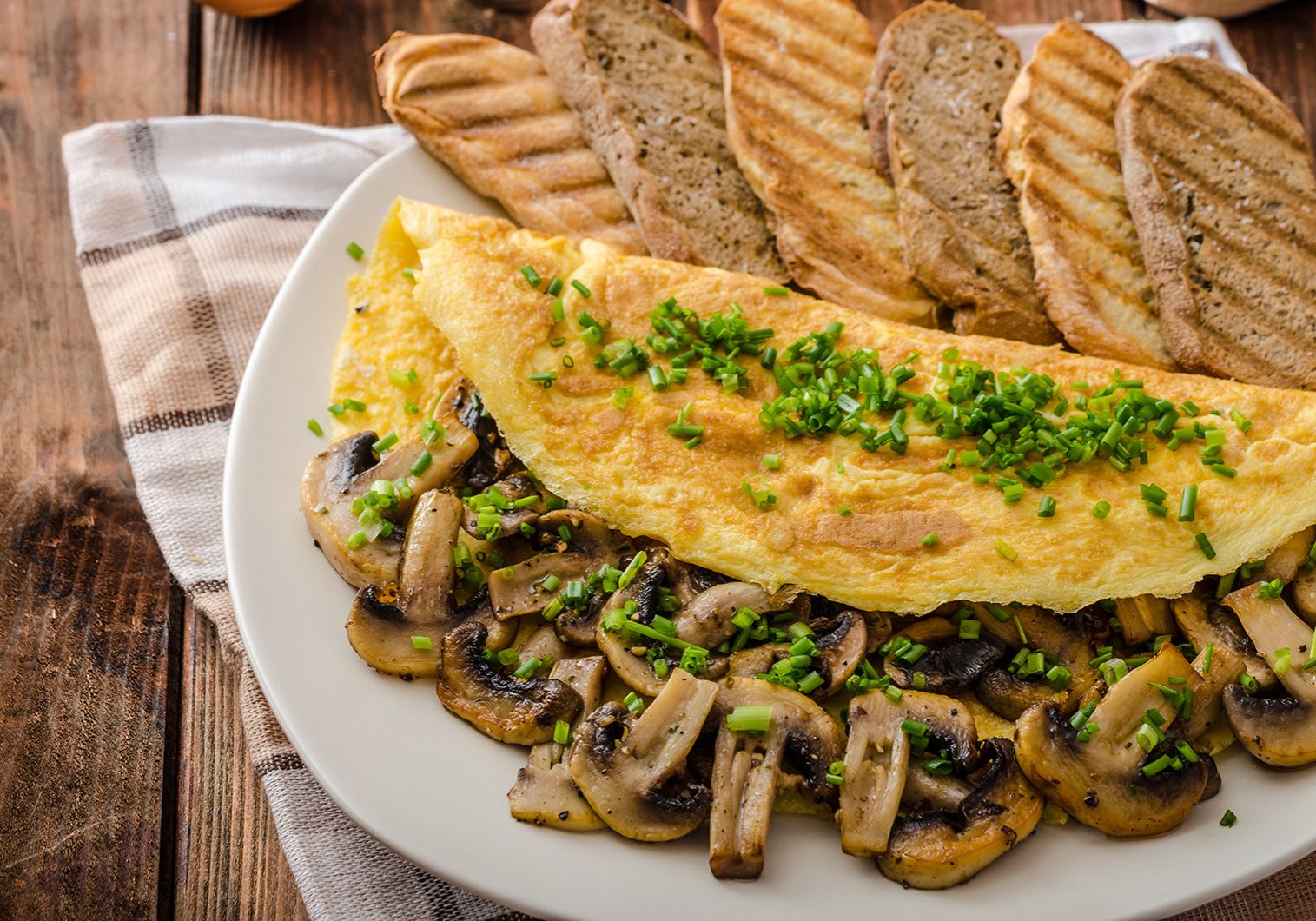 Rustic omelette with mushrooms on chives, roasted panini health bread