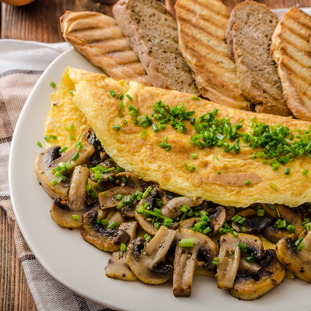 Rustic omelette with mushrooms on chives, roasted panini health bread